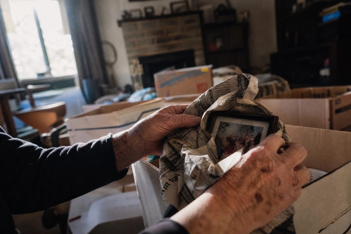 Hands wrapping a family photo